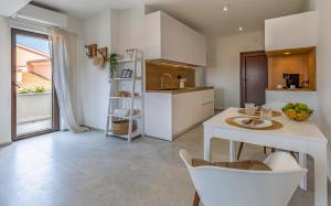a kitchen with a table and chairs and a sink at Studio Percan in Premantura