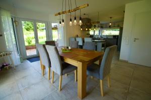 a kitchen and dining room with a wooden table and chairs at Ferienhaus Plattenberg in Bad Oeynhausen