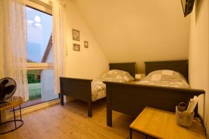 a bedroom with two beds and a large window at Ferienhaus Plattenberg in Bad Oeynhausen