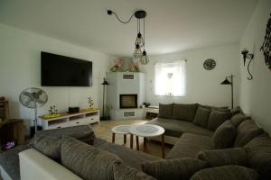 a living room with a couch and a table at Ferienhaus Plattenberg in Bad Oeynhausen