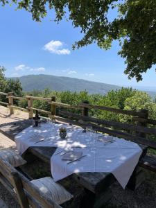 ein Tisch mit einer weißen Tischdecke in der Unterkunft La planina in Prepotto