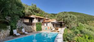 a villa with a swimming pool in the mountains at Arriva Villas in Sivota