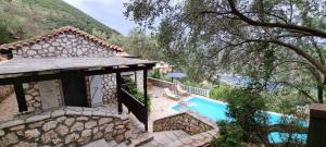 an image of a villa with a swimming pool at Arriva Villas in Sivota
