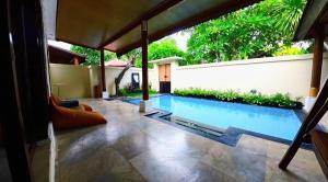 a swimming pool in the middle of a yard at One Bedroom Private Pool Classic Villa in Kuta
