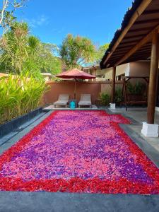 a large carpet of red and purple flowers on a patio at One Bedroom Private Pool Classic Villa in Kuta