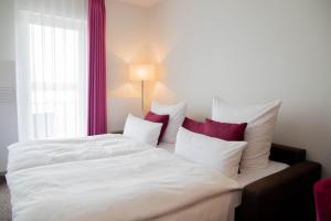 Postel nebo postele na pokoji v ubytování Fontane Hotel