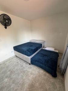 two beds in a room with blue sheets at Casa San Miguel 101 in Medellín