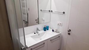 a white bathroom with a sink and a mirror at Blooming by the Sea - camere cu vedere frontală spre mare in Olimp +43 photos