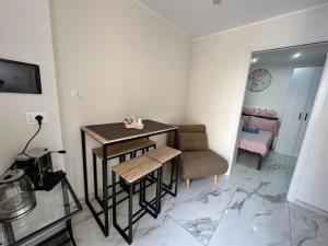 a small room with a table and a chair at Casa Vacanza - PERLA MARINA- 40 mt dal mare in Crotone +3 photos