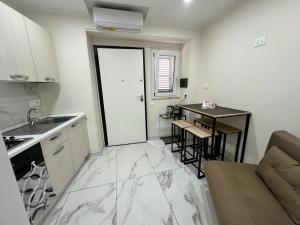a small kitchen with a table and a counter top at Casa Vacanza - PERLA MARINA- 40 mt dal mare in Crotone