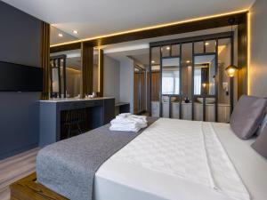 A bed or beds in a room at Adora Calma Beach Hotel Adults Only