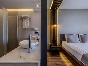 A bed or beds in a room at Adora Calma Beach Hotel Adults Only