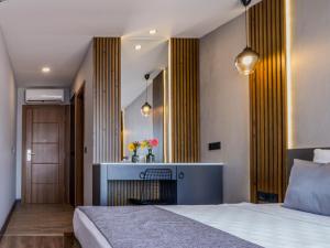 A bed or beds in a room at Adora Calma Beach Hotel Adults Only