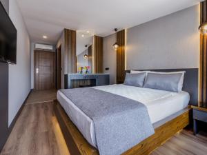 A bed or beds in a room at Adora Calma Beach Hotel Adults Only