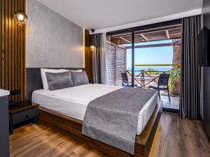 A bed or beds in a room at Adora Calma Beach Hotel Adults Only