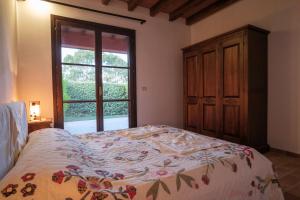 a bedroom with a bed and a large window at Agriturismo Niccoland in Grosseto +54 photos