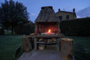 a fire in a stone oven in a yard at Agriturismo Niccoland in Grosseto