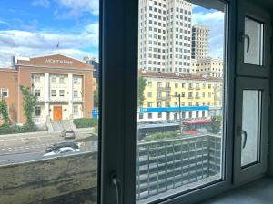 a view of a city from a window at Urban Suites Spacious 2-Bedroom Apartment in Taryaatayn Baraanii Bayshing