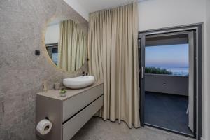 a bathroom with a sink and a mirror at Villa Roma Sauna and Hydrotherapy Pool in Trogir