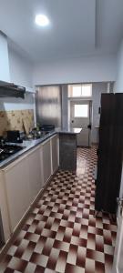 a kitchen with a checkered tile floor in a kitchen at Casas do Cinema II in Mindelo
