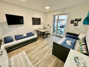 TV a/nebo společenská místnost v ubytování Carefree Mikroapartment inkl. Balkon + Tiefgarage