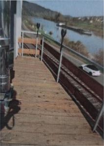 a boardwalk with two parking meters next to a body of water at Ferienhaus zur Moselfähre in Kröv