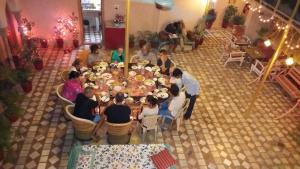a group of people sitting around a long table at Tanisha Heritage Haweli in Bikaner