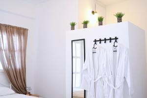 a dressing room with a mirror and a white robe at Panorama View Kanala in Kithnos
