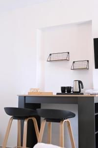 a desk with two stools in front of a table at Panorama View Kanala in Kithnos