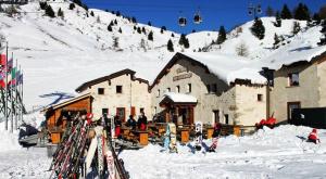 a ski lodge with a bunch of skis in the snow at Il Faita in Passo del Tonale