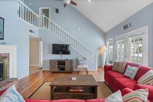 a living room with a red couch and a tv at Sunset Daze in Gulf Shores