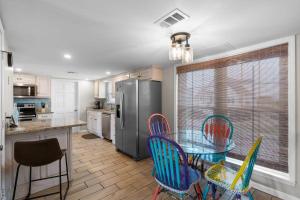a kitchen with a table and chairs and a refrigerator at Sunset Daze in Gulf Shores