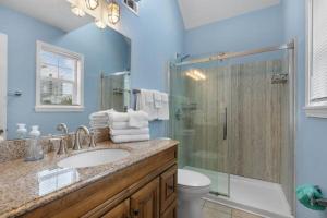 a bathroom with a shower and a sink and a toilet at Sunset Daze in Gulf Shores +28 photos