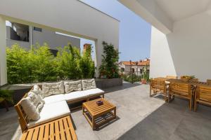 a patio with a couch and a table at Zen House in Zadar +35 photos