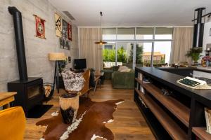 a living room with a fireplace and a couch at Zen House in Zadar