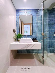 a bathroom with a sink and a mirror at Ibiza Hải Tiến in Thanh Hóa
