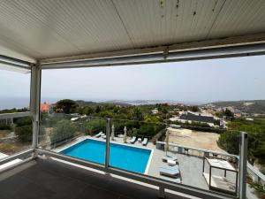 a view from the balcony of a house with a swimming pool at Dela in Hvar