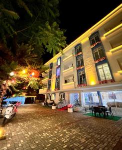 a building at night with a cobblestone street in front at Anatolia Hotel Airport in Trabzon
