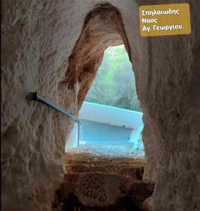 a view of a stairway in a cave with a window at Eleni House in Didyma