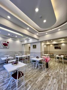 a dining room with white tables and chairs at Anatolia Hotel Airport in Trabzon