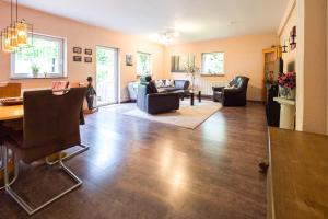 a living room with a table and chairs at Forsthaus Halbemark in Bad Sooden-Allendorf
