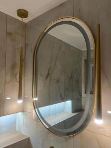 a bathroom with a round mirror on the wall at Akadia Syros in Ermoupoli +53 photos
