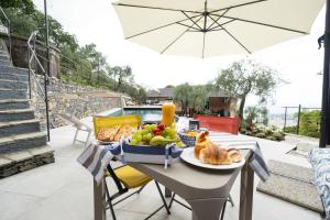 a table with a basket of food on a patio at Vista Mare Portofino by PortofinoVacanze in Gravero