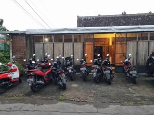 a group of motorcycles parked in front of a building at Bayt Assalaam Syariah Homestay in Klaten