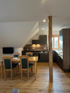 a kitchen and dining room with a table and chairs at Rebenlandhof in Leutschach