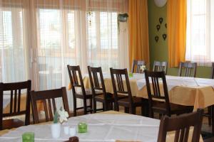 a dining room with tables and chairs and windows at Rebenlandhof in Leutschach +49 photos