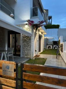 a backyard with a wooden bench and a house at Momo's House in Nikiti