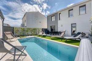 a swimming pool in the backyard of a house at Maison des Marais 5 Etoiles La Chaume Piscine in Les Sables-dʼOlonne