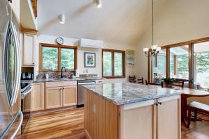 a kitchen with a refrigerator and a counter top at Meadow Cove in Boothbay