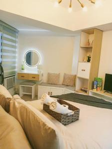 a room with a bed and a living room with a mirror at Sam's Chic Space - An Aesthetic Getaway in Angeles
